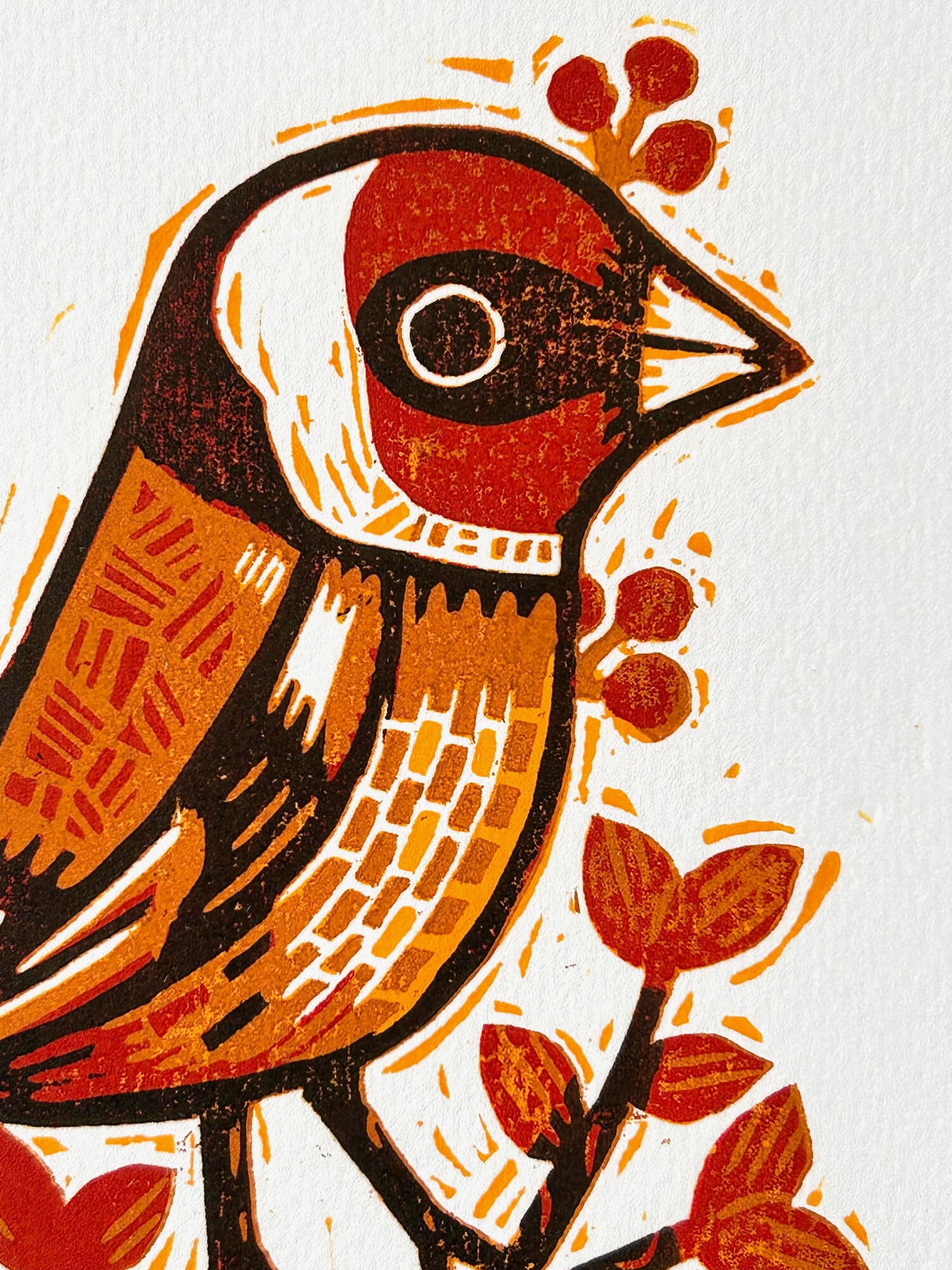 Woodcut-style illustration of a bird with red and brown colors on a white background