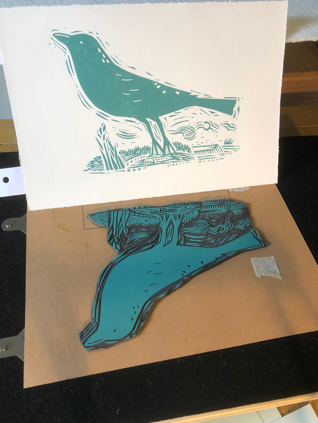 printmaking process of teal blackbird linocut artwork