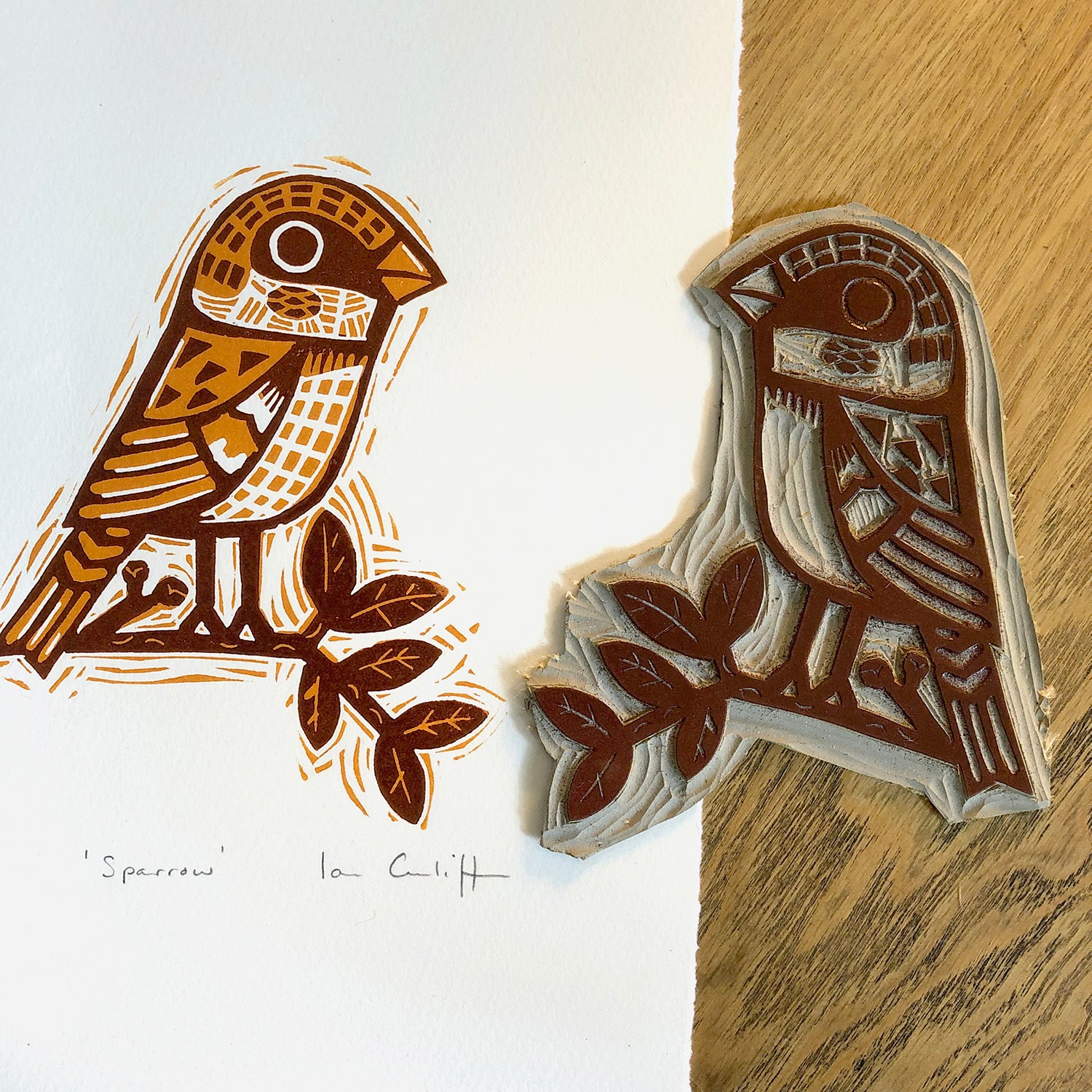 linocut sparrow bird design block print on a wooden surface