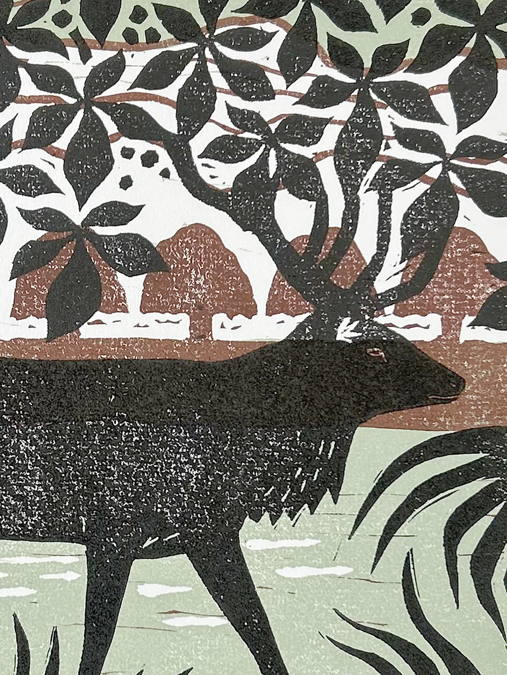 Artistic silhouette of a stag in a natural setting.