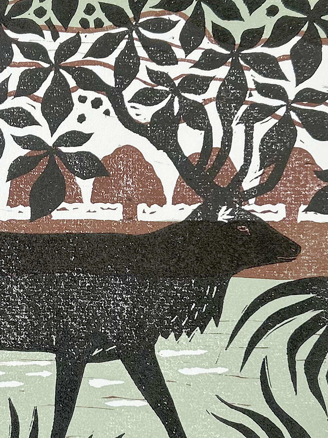 Artistic silhouette of a stag in a natural setting.