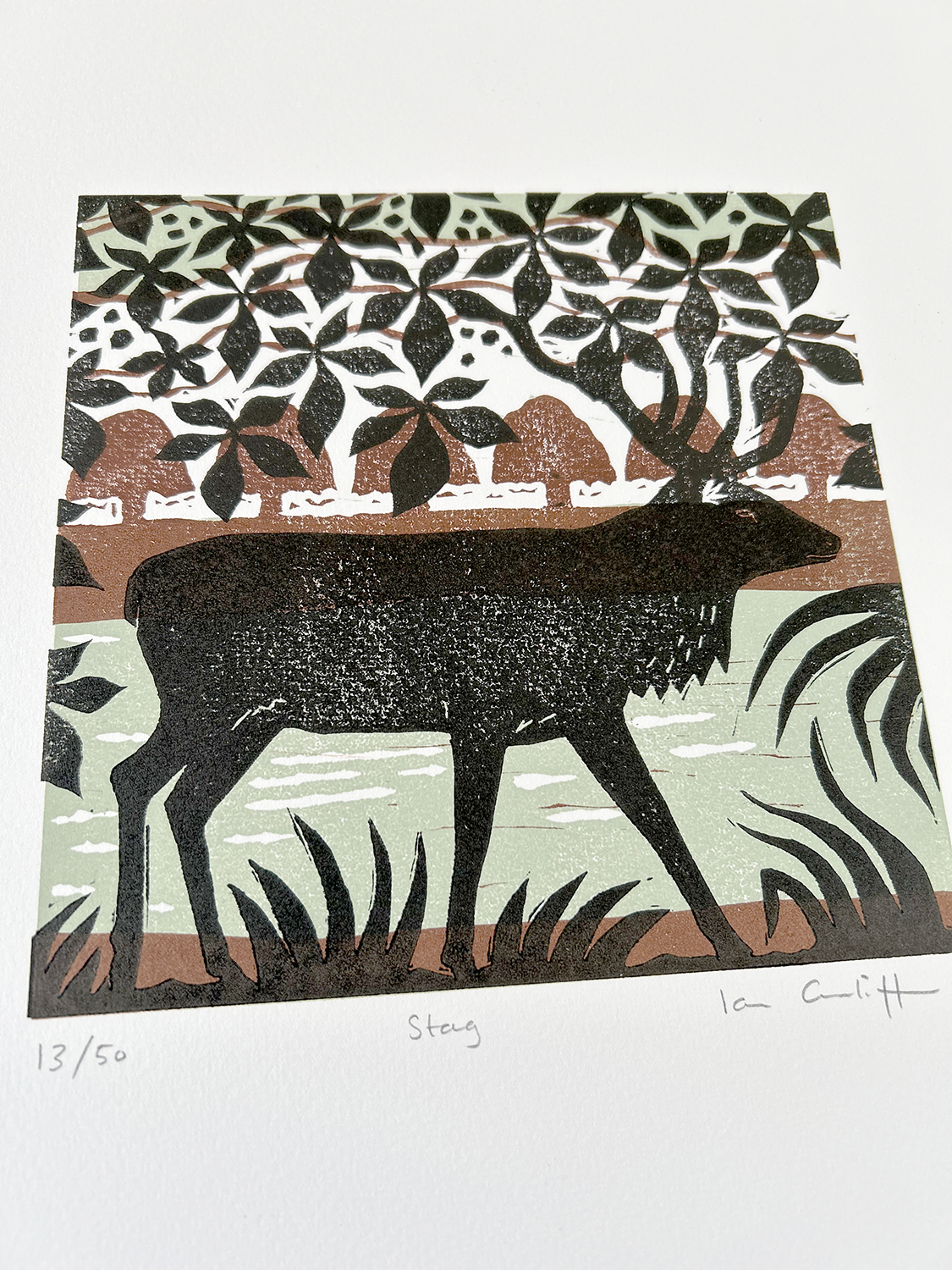 Decorative print of a deer with floral and geometric patterns on a white background