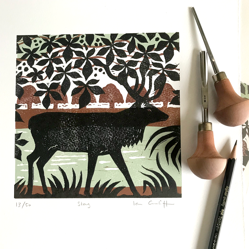 Hand-carved stag linocut print showing detailed forest scene with trees and natural woodland setting