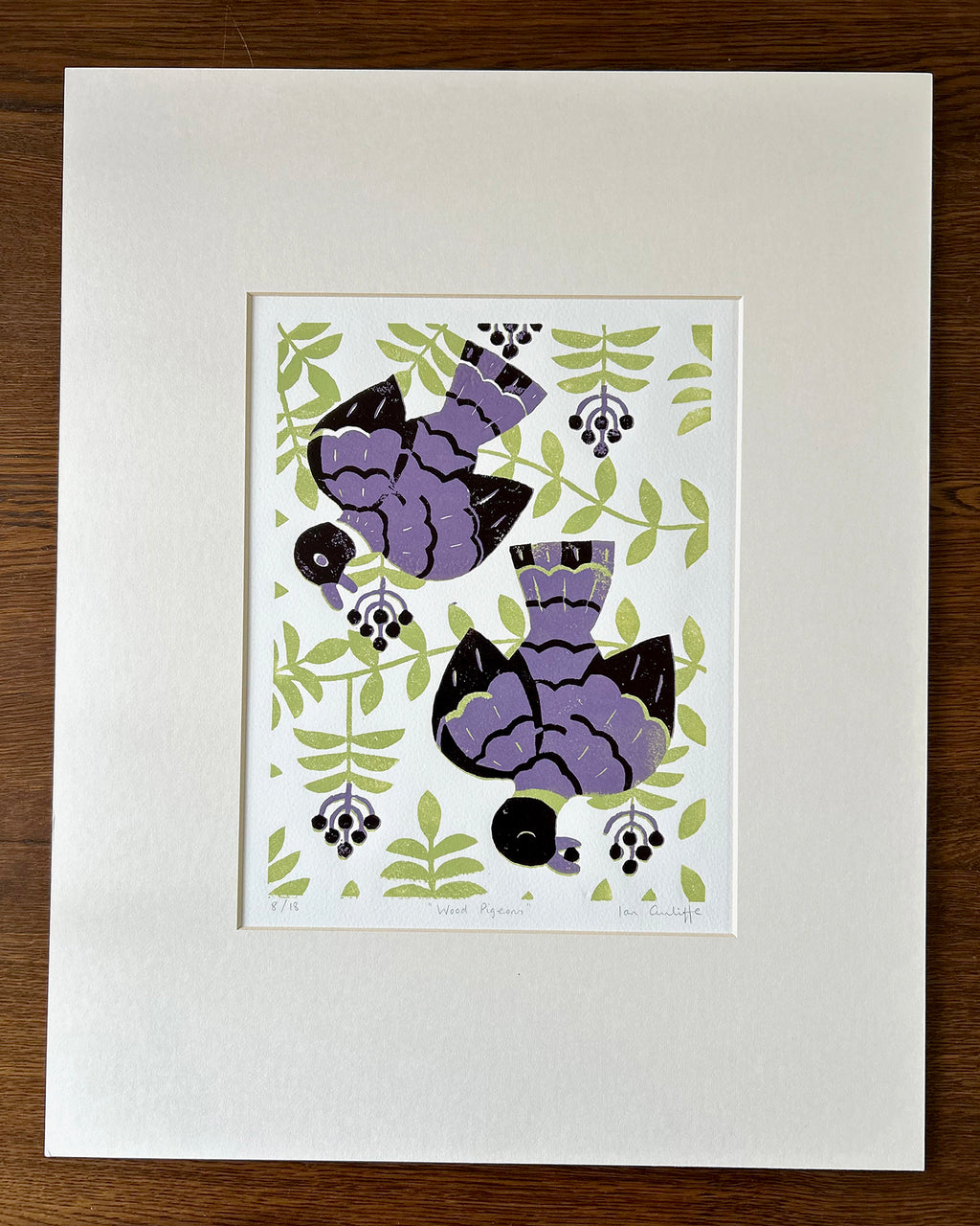 Mounted artwork of  a pair of wood pigeons on branches, hand-carved linocut print with delicate feather detail and soft organic textures